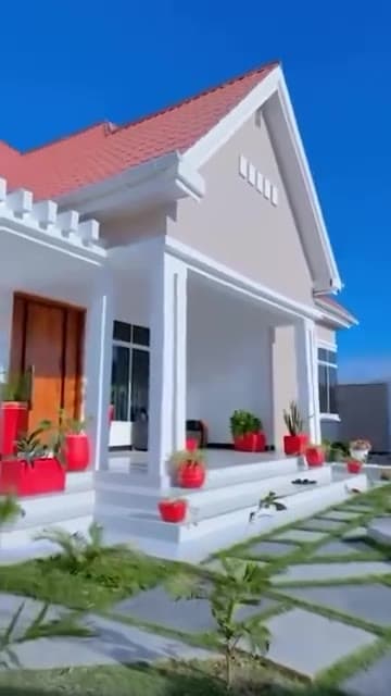 Mbweni home with a bright exterior, red tiled roof and welcoming front steps